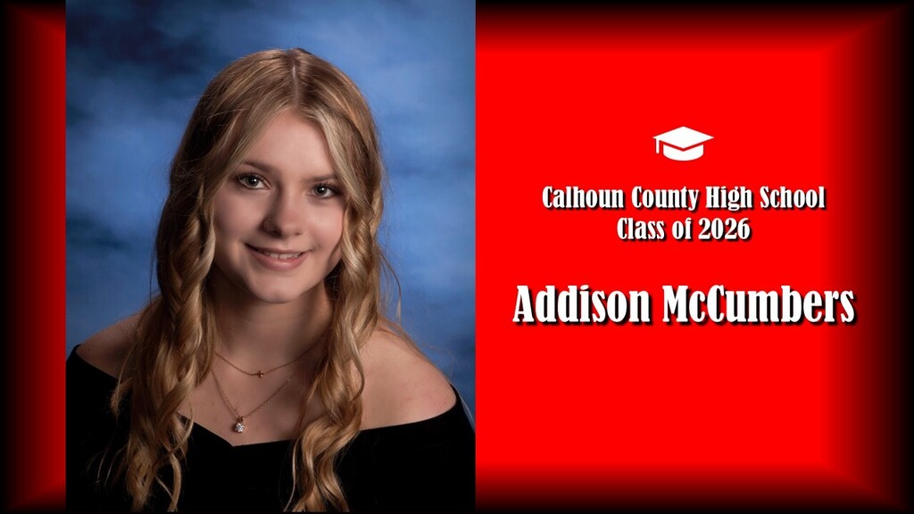 Student wearing black drape with blonde hair and red background. States it's the class of 2026 from Calhoun County High School. Student name is "Addison McCumbers"