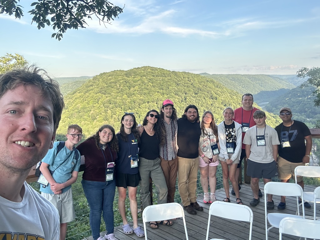 Group of students posing with WV mountains in the background