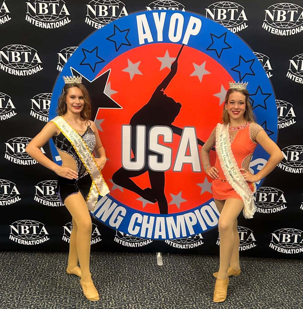 Cariss and Trinity pose with their WV titles with the AYOP back ground