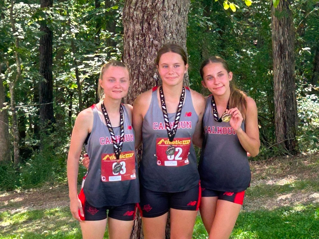 Gabbi, Carissa, and Brook pose with their medals from the varisy XC race