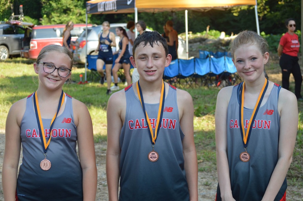 MS runners pose after the race with medals round their necks.