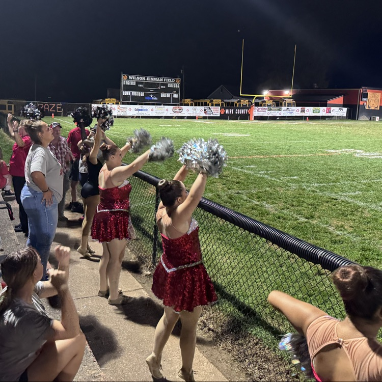 auxiliary team is dancing to the fight song.