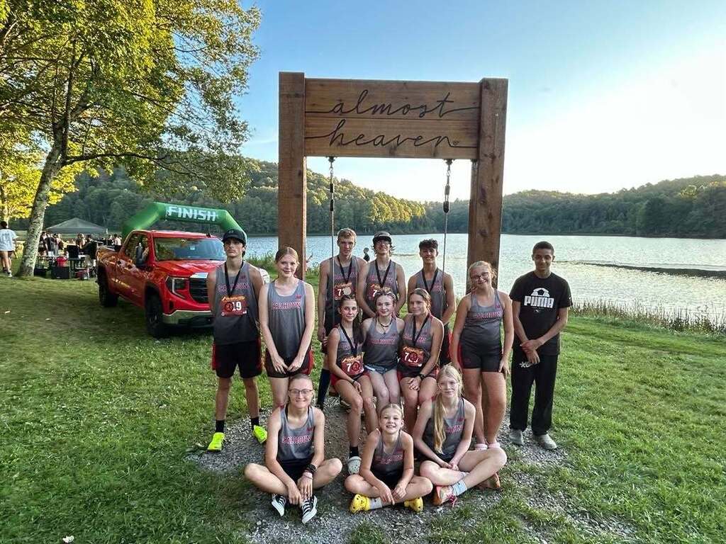 Team picture at the Almost Heaven sign at the lake. 