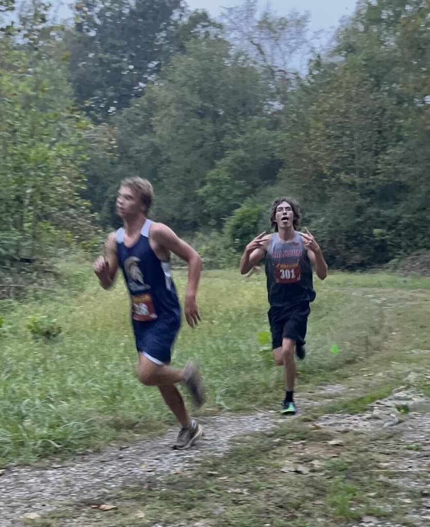 Clawson gives peace signs at the camera as he runs the course. 