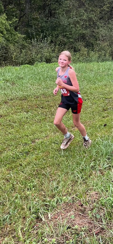 Lillian Caldwell  smiles for the camera while running the trail. 