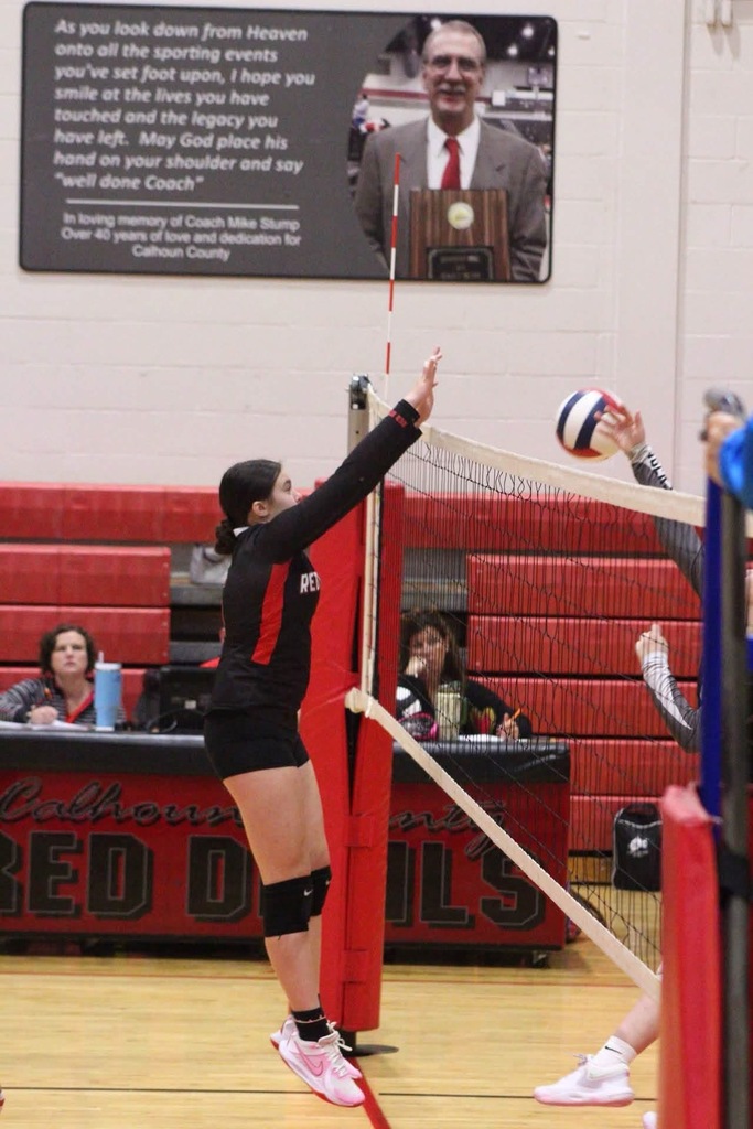 Calhoun send the volleyball over the net. 