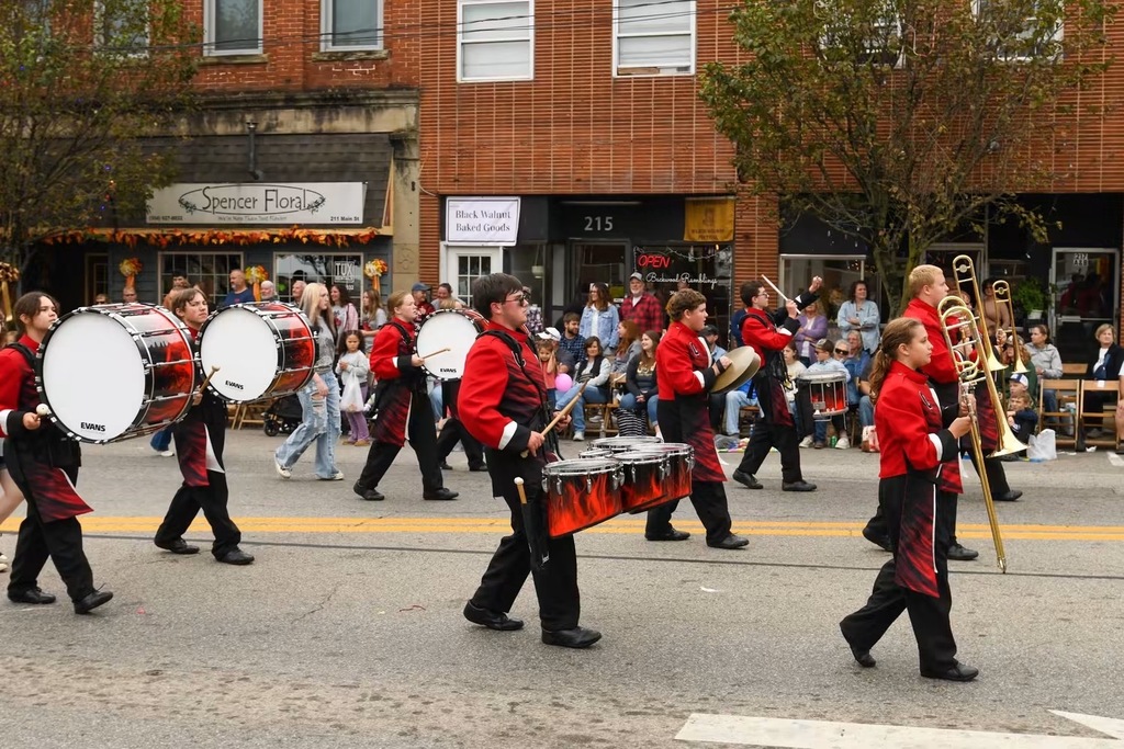 Highlighting the perscussion marching in the parade on the main road
