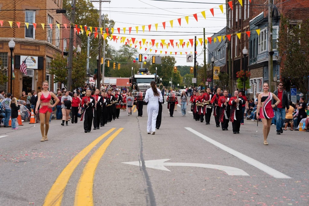 Calhoun Marching band marching down main street with Feature Twilers leading the way. 