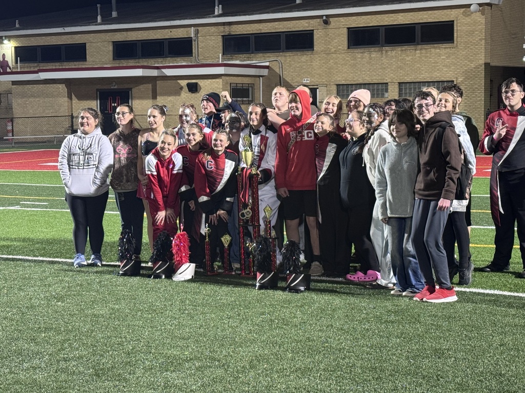 entire band stands with awards from competition green turf
