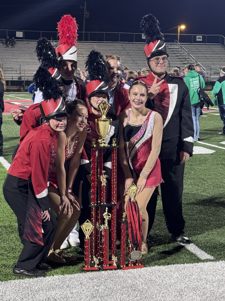 9 students pose with all awards earned at competition.