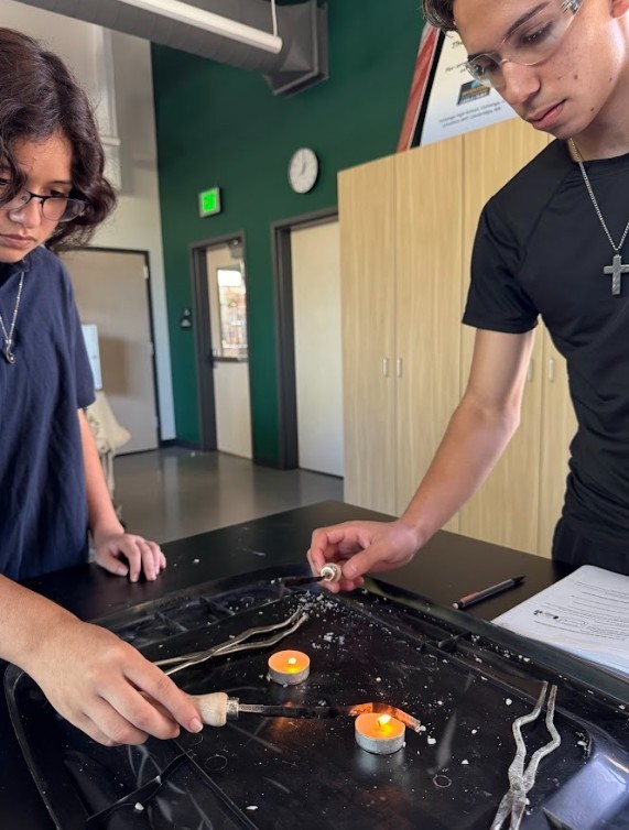 students lighting up a candle