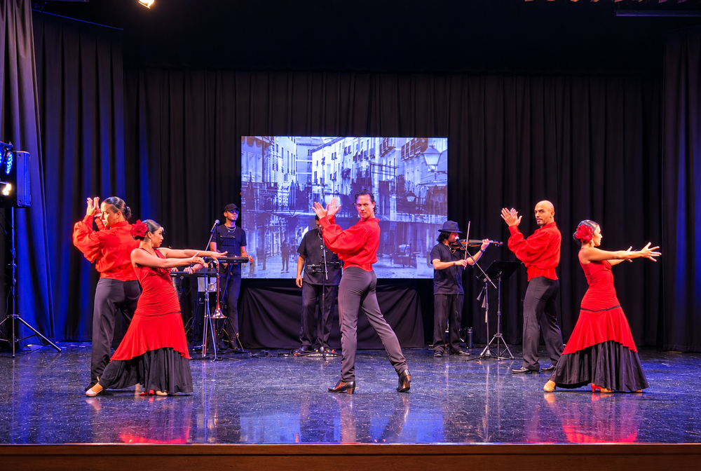 Flamenco dancers and live musicians on a stage.