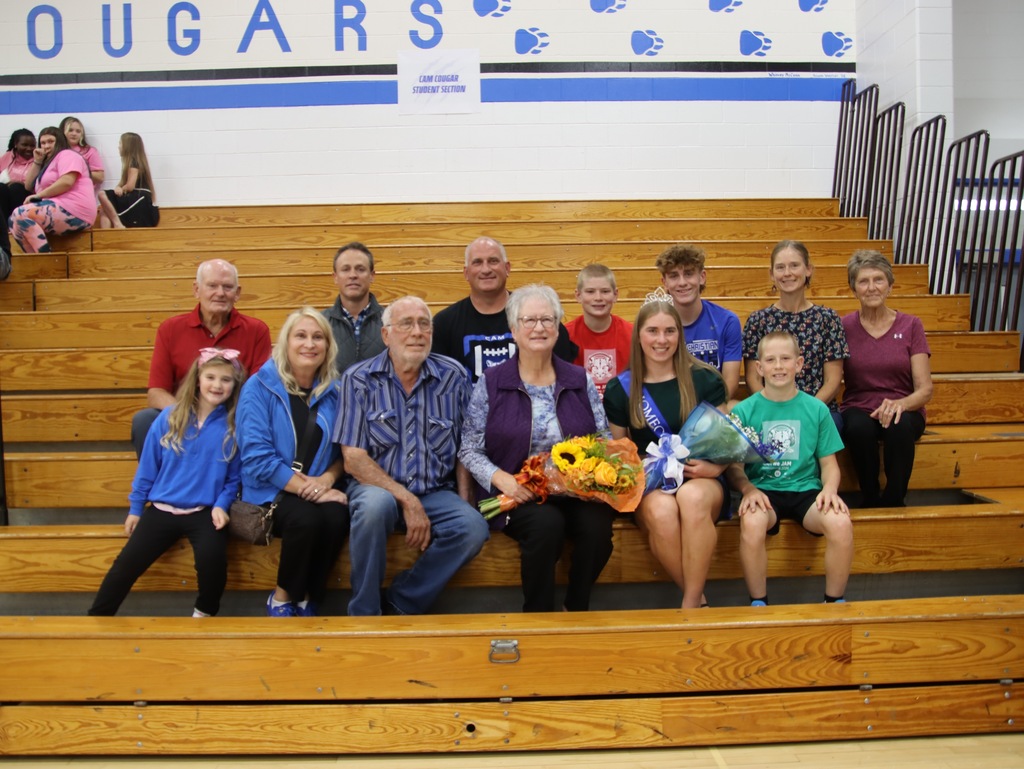 Mrs. Kay Hansen and her family on the bleachers