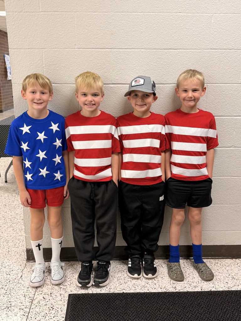 student line up against wall to show off American flag tee-shirts