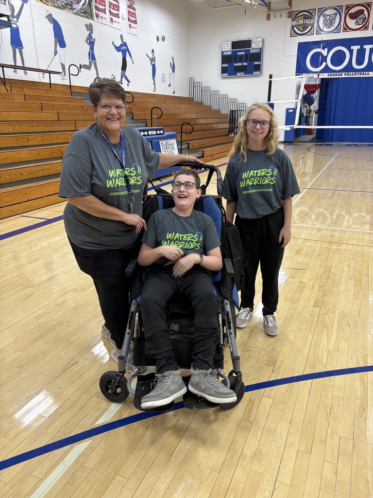 A set of triplets dressed in Water's Warriors shirts and black pants.