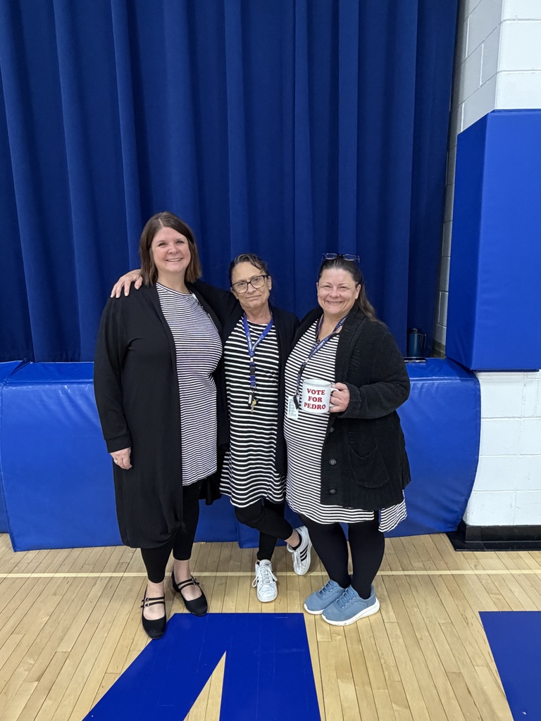A triplet of teachers dressed in black leggings, black sweater and a gray shirt