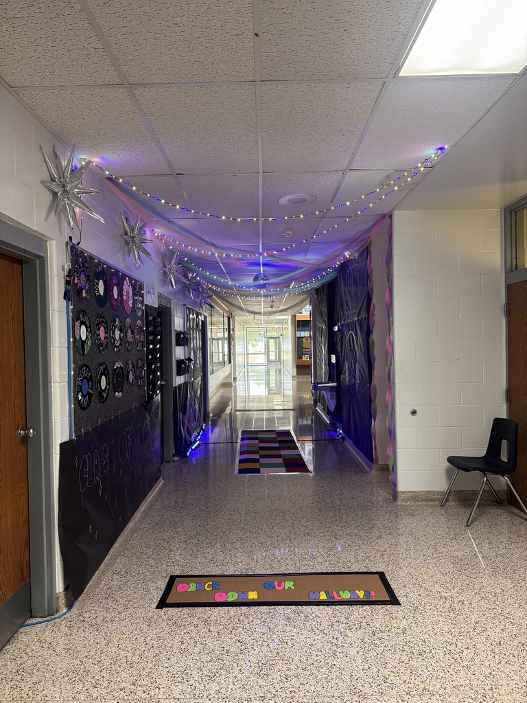 Juniors decorated hallway with lights draped above the ceiling, a checkered dance floor and music playing