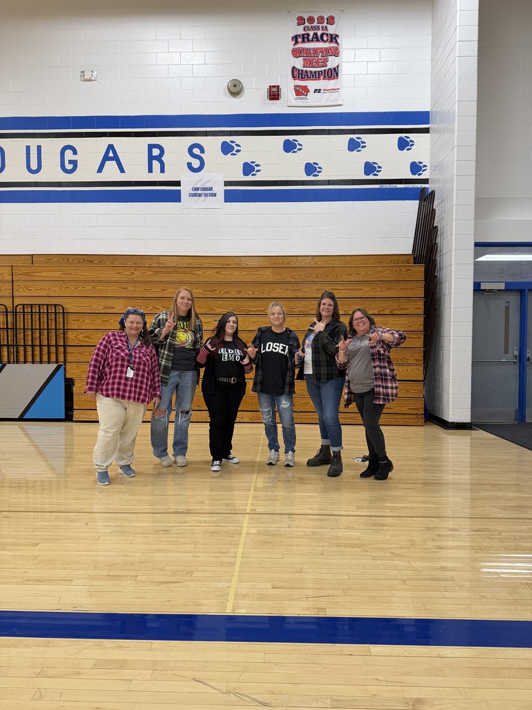 Staff dressed in their 90's grunge outfits - The winner has on Black pants, a shirt that says Elder EMO