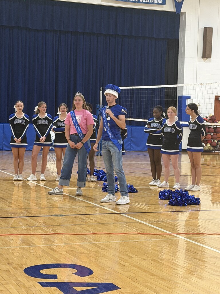 Homecoming King and Queen speaking to Elementary students in the gym
