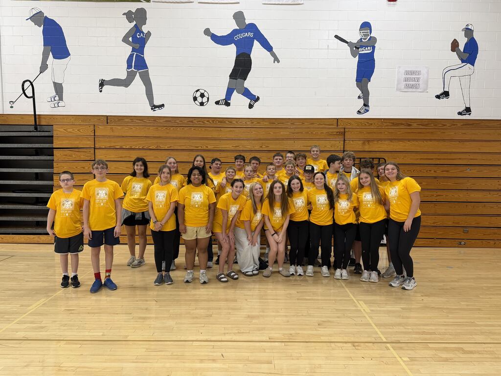 8th graders dressed in yellow in the gym