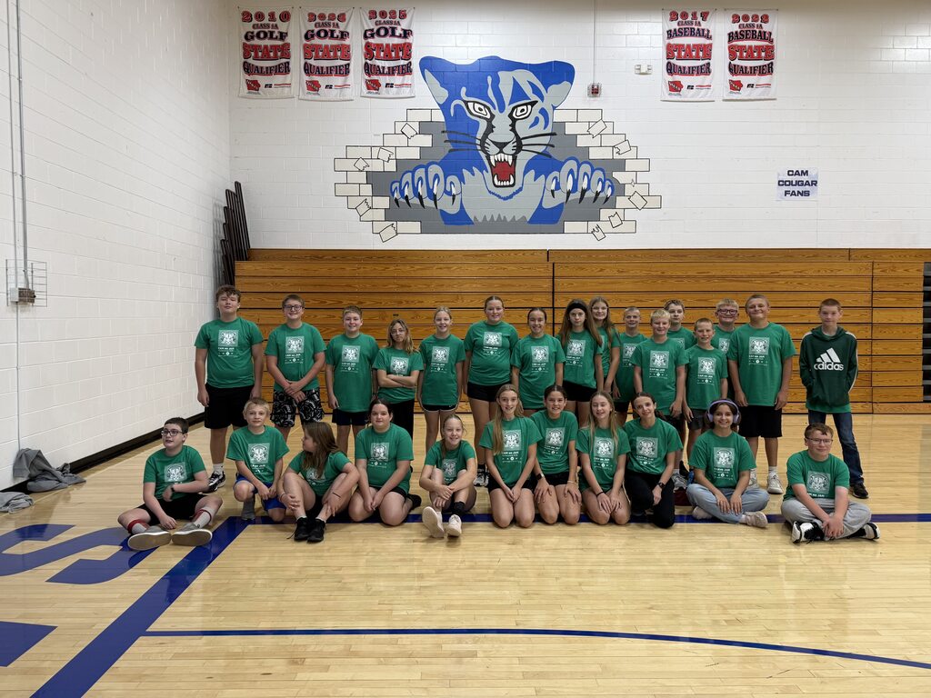 7th graders dressed in green in the gym
