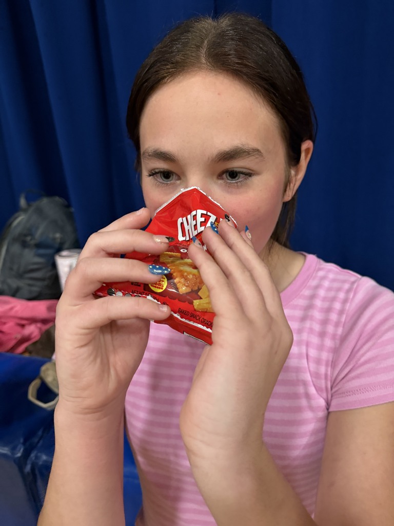 cam volleyball player drinking water out of a cheezit bag