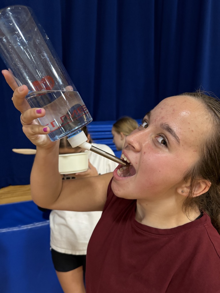 one volleyball player drinking out of a gerbal drink tube