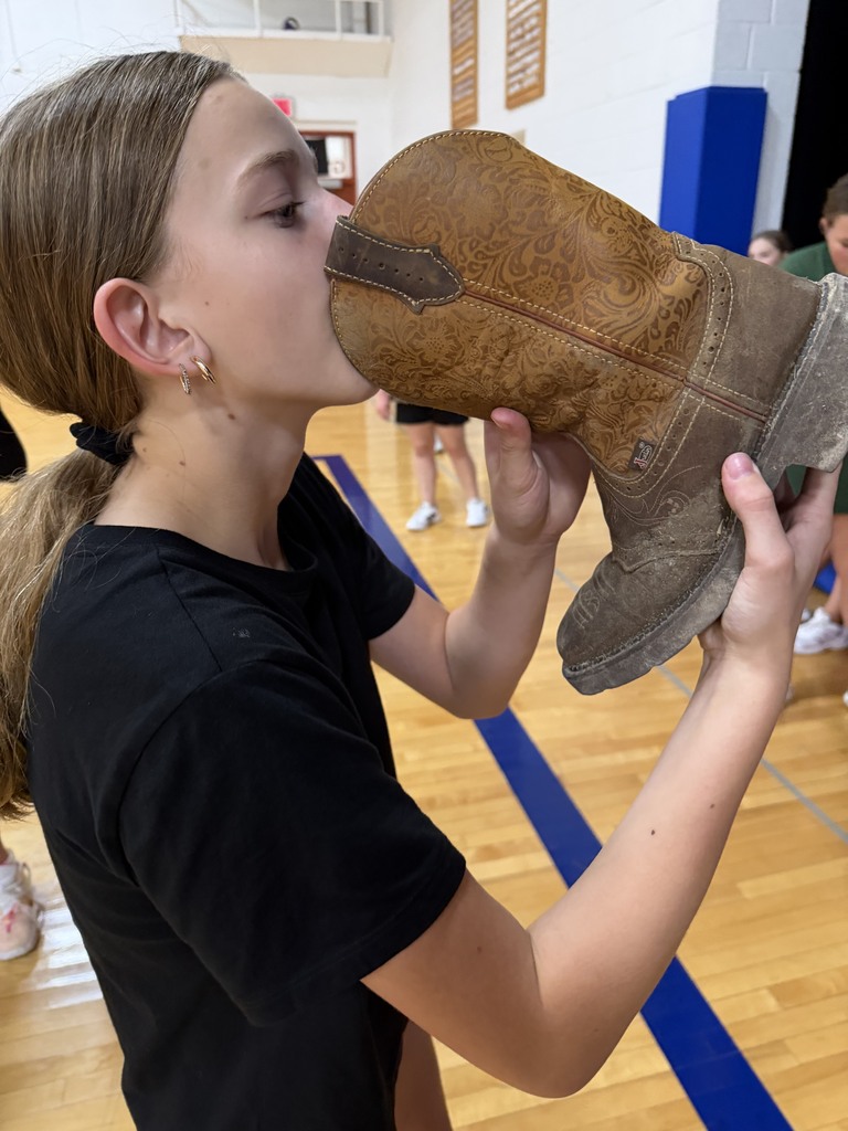 one volleyball player drinking out of a cowgirl boot