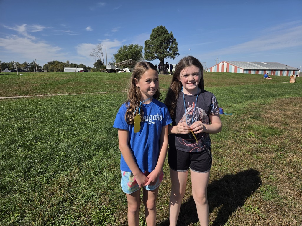 Two girls having fun participating in the mileage club at recess