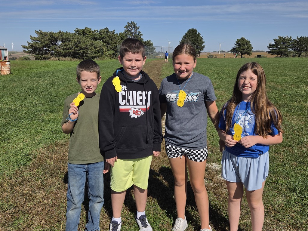Four kids walking laps at the mileage club during recess