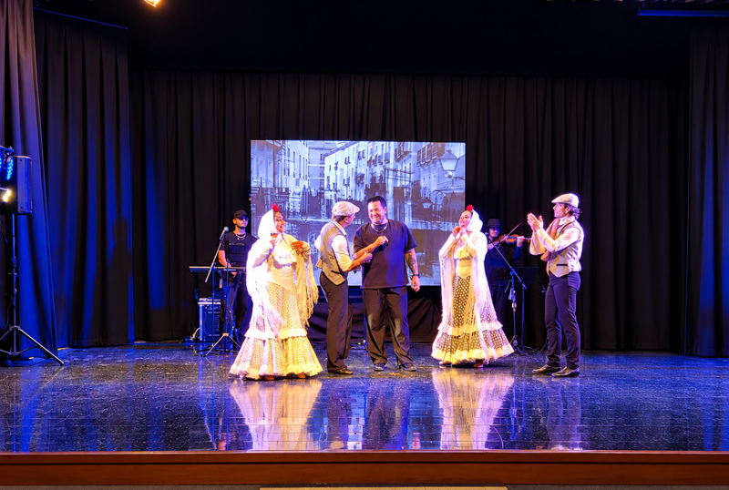 Dancers in traditional Madrid clothing singing and dancing live on stage