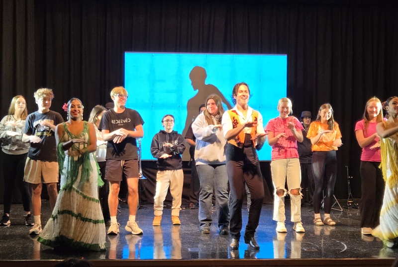 CAM students dancing on the stage with the professional dancers and other schools.