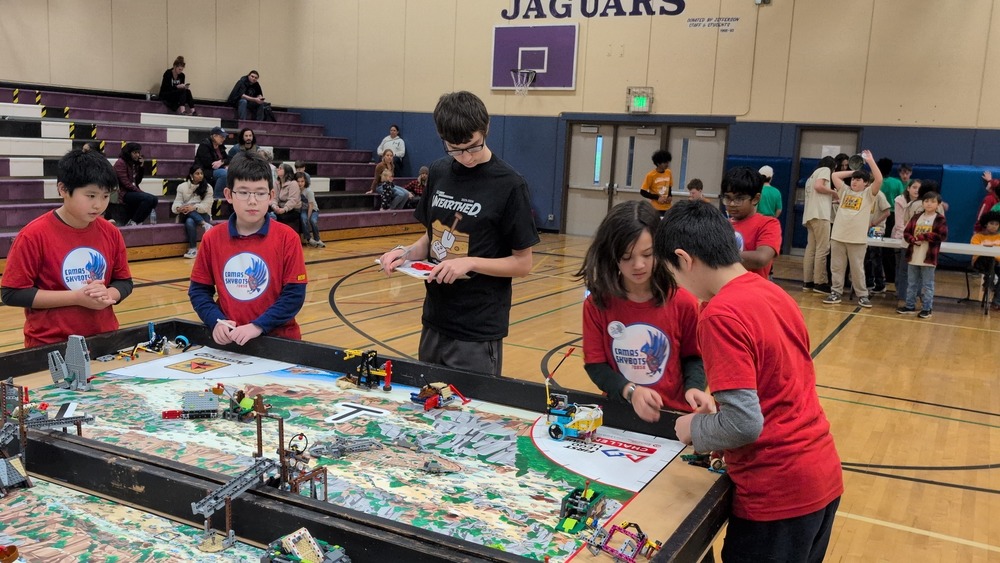 Student competing with robots