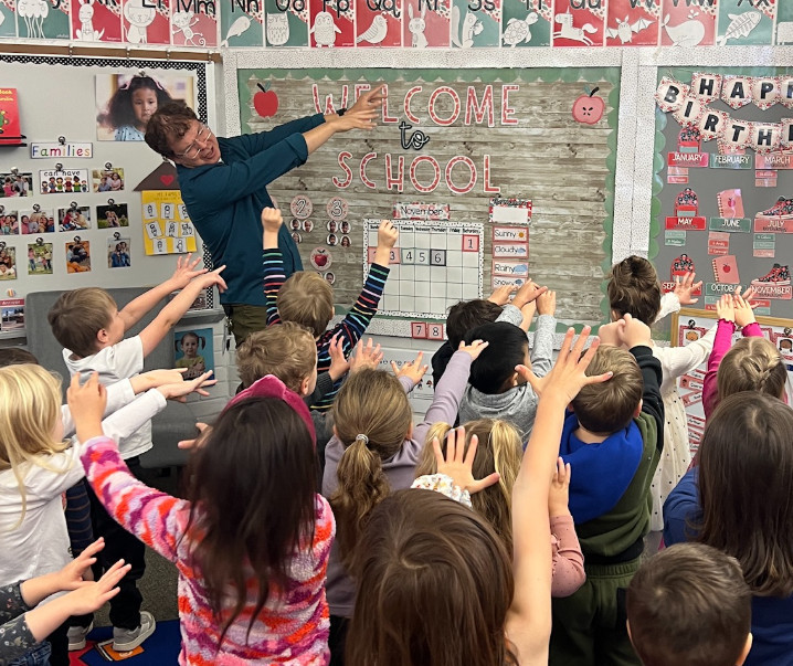 Adult stretching with students