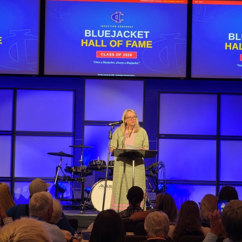 A speaker speaks at a podium during the Bluejacket Hall of Fame Class of 2026 induction ceremony.
