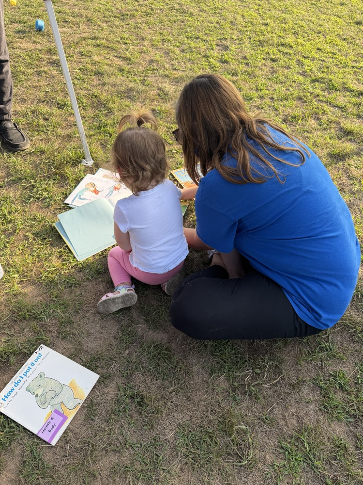 Teacher and child reading together 