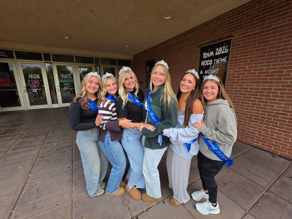 Six students wearing sashes and tiaras pose together outdoors for 2026 Homecoming Court.