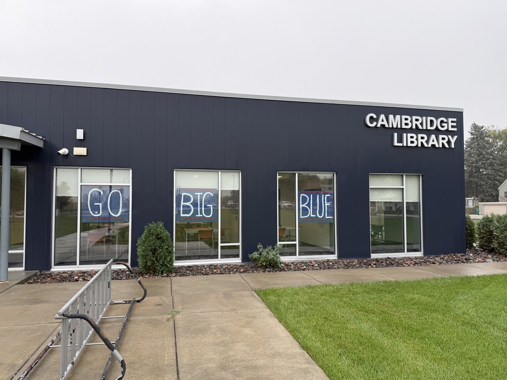The Cambridge Library's windows are decorate for Bluejacket Homecoming. The windows say GO BIG BLUE.