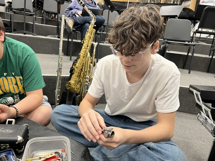 JH students learning how to clean and maintain musical instruments