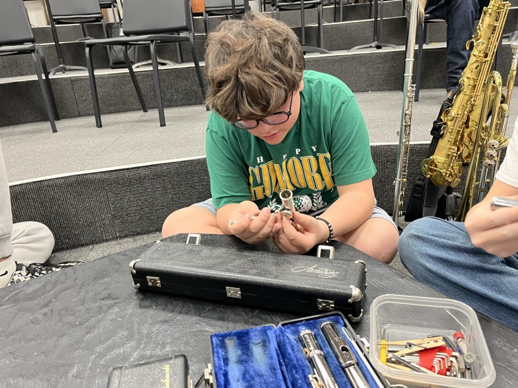 JH students learning how to clean and maintain musical instruments