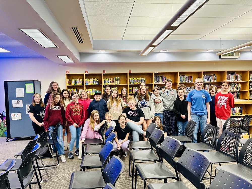 Group Photo of Students with Author Megan E. Freeman in the Library