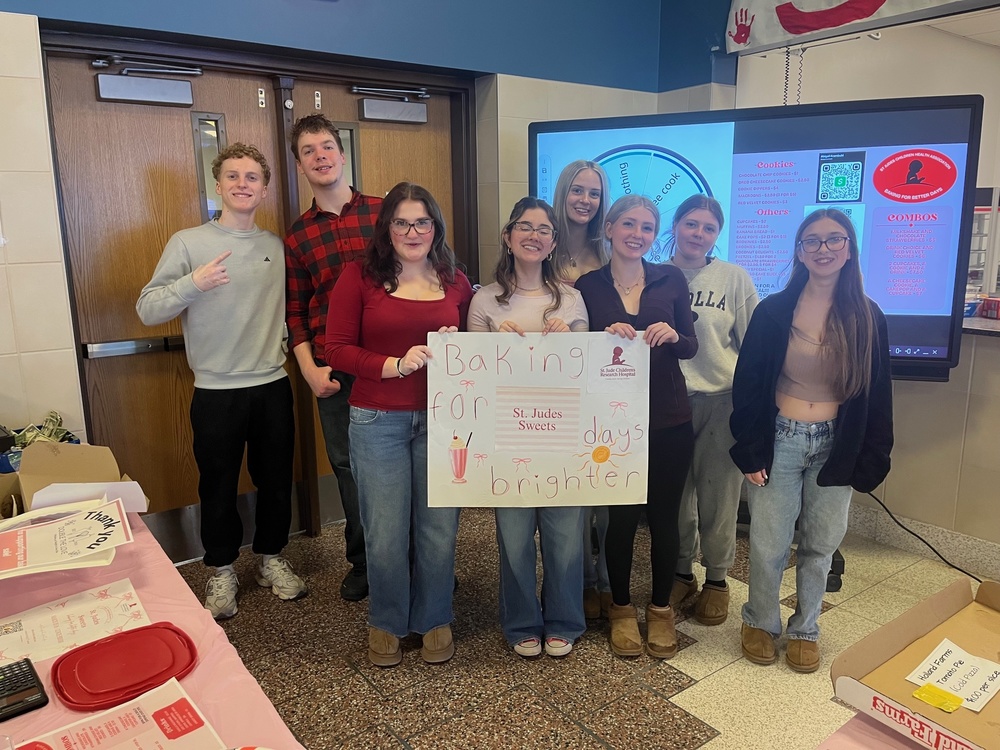 The Winning Team "St. Jude Sweets" poses for a team photo behind their table