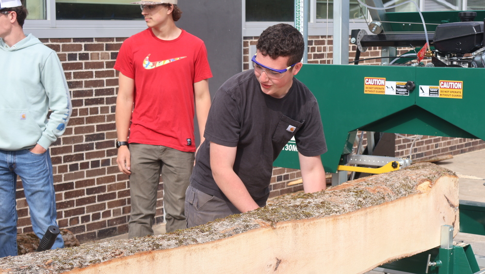 Student Setting A Log on the Sawmill