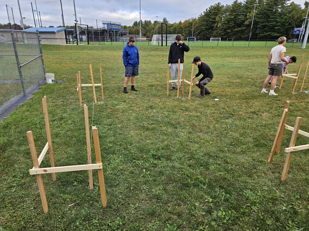 Mr. Petrie's Residential Structures class spent the last 2 weeks learning about plot plans and building lines. Students modeled a building layout using plywood, nails and string, keeping a critical eye on accurate measurements. Later, they got into groups of 4 and applied this knowledge to a full scale site. Groups took time to layout a perfectly square 8' x 12' building. They drove stakes and leveled line just like the professionals in the real world. By the end, students were ready for a (hypothetical) excavator to start digging! 