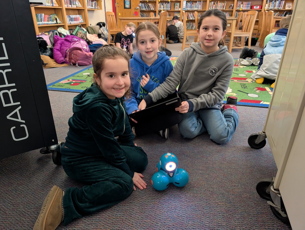 Pairings of students participating in a Robotics activity with Dash and Dot Robots. Each photo has two students and the laptop they're using to  program the robots. 