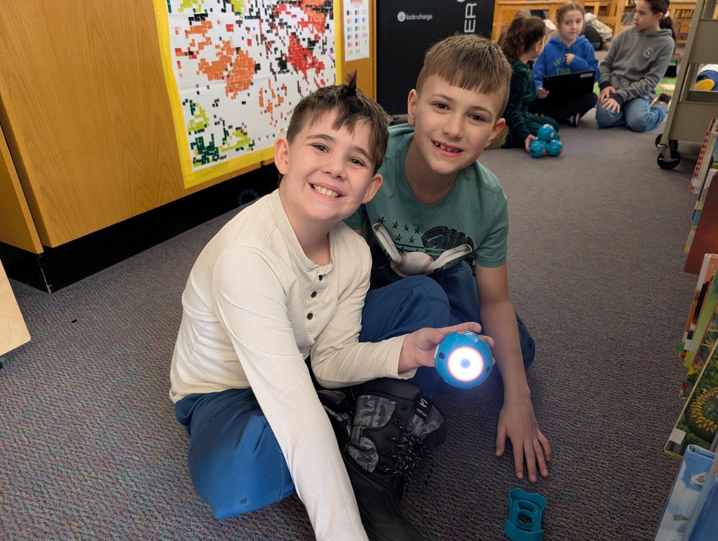 Pairings of students participating in a Robotics activity with Dash and Dot Robots. Each photo has two students and the laptop they're using to  program the robots. 