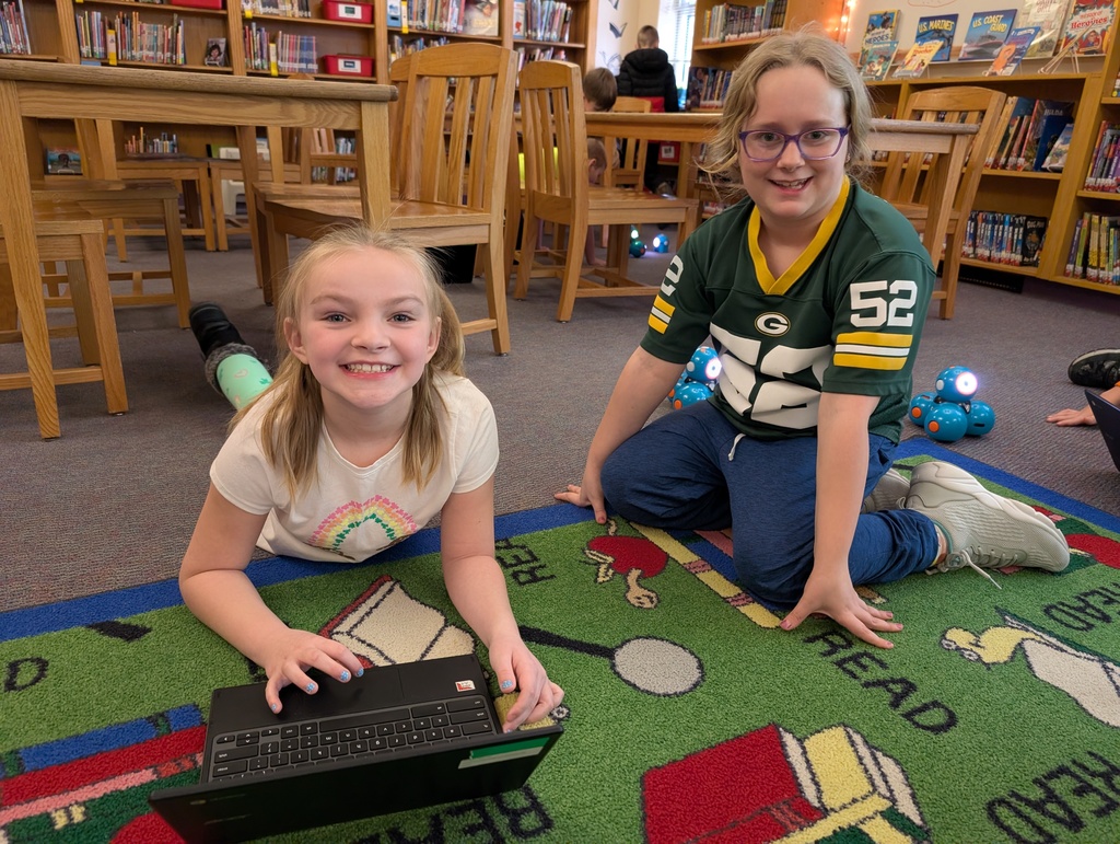 Pairings of students participating in a Robotics activity with Dash and Dot Robots. Each photo has two students and the laptop they're using to  program the robots. 