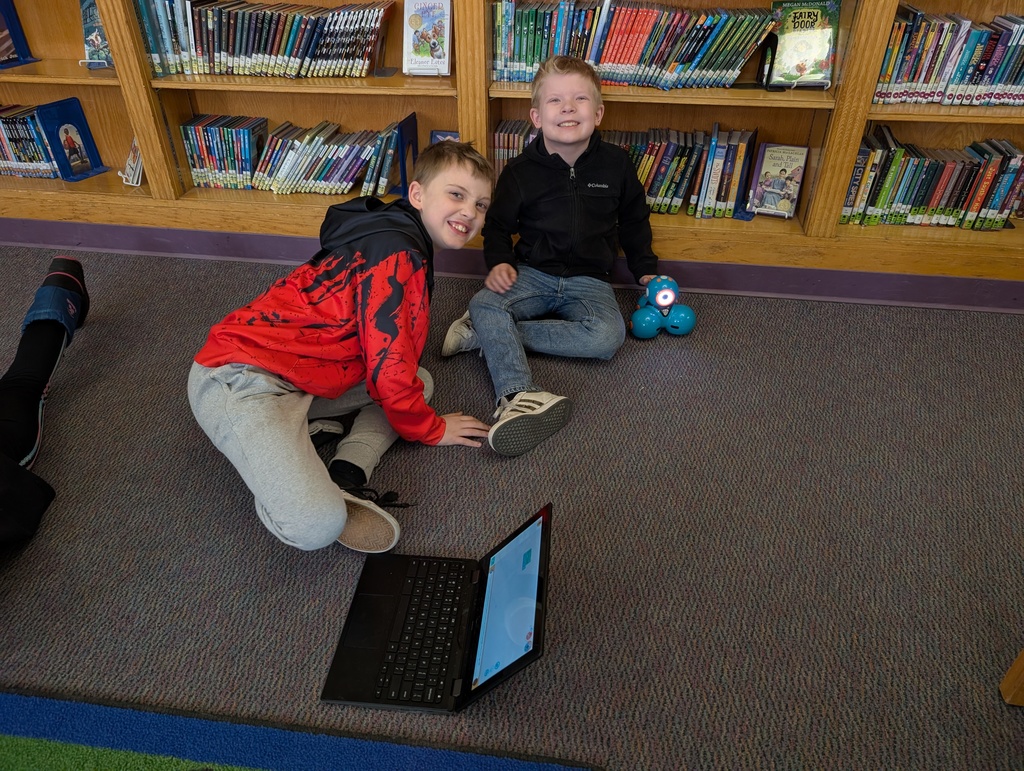 Pairings of students participating in a Robotics activity with Dash and Dot Robots. Each photo has two students and the laptop they're using to  program the robots. 