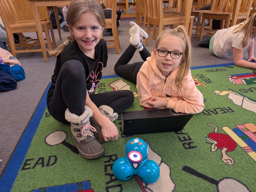 Pairings of students participating in a Robotics activity with Dash and Dot Robots. Each photo has two students and the laptop they're using to  program the robots. 