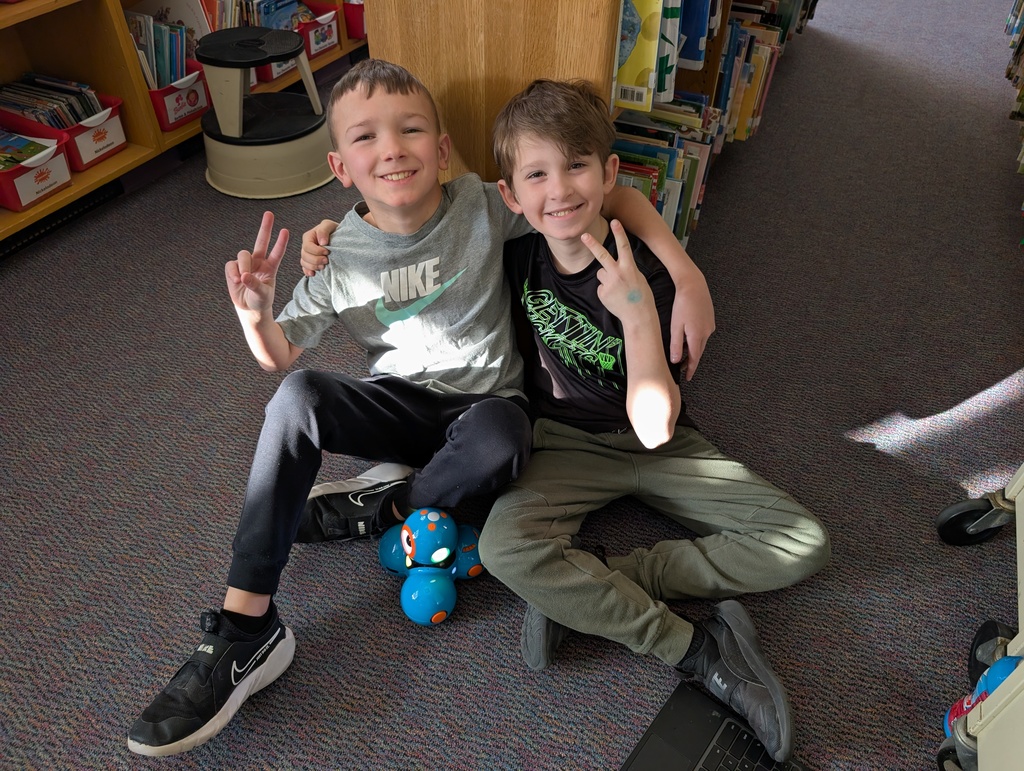 Pairings of students participating in a Robotics activity with Dash and Dot Robots. Each photo has two students and the laptop they're using to  program the robots. 